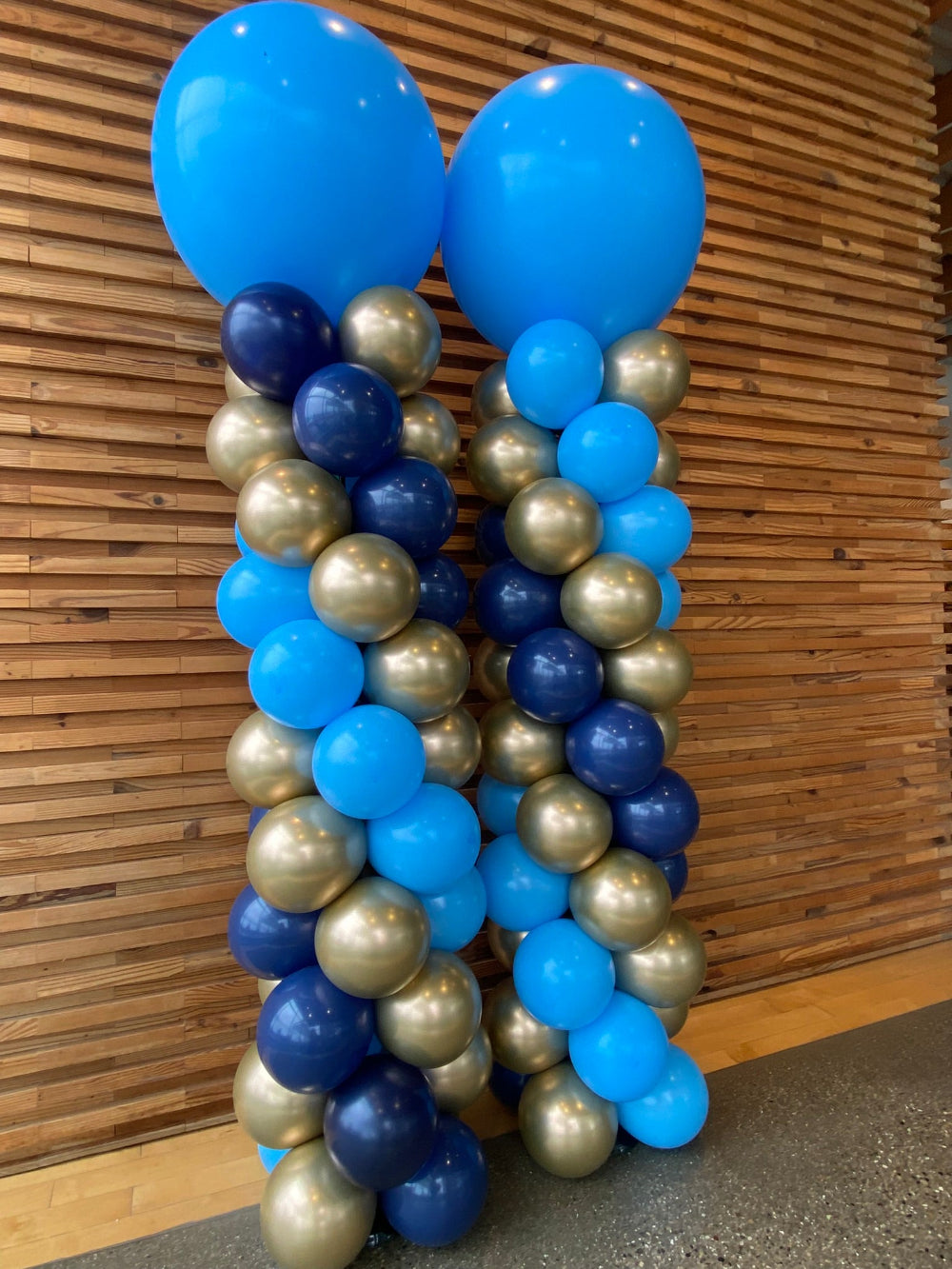light blue, navy and silver balloon columns for entryway in Grand Rapids